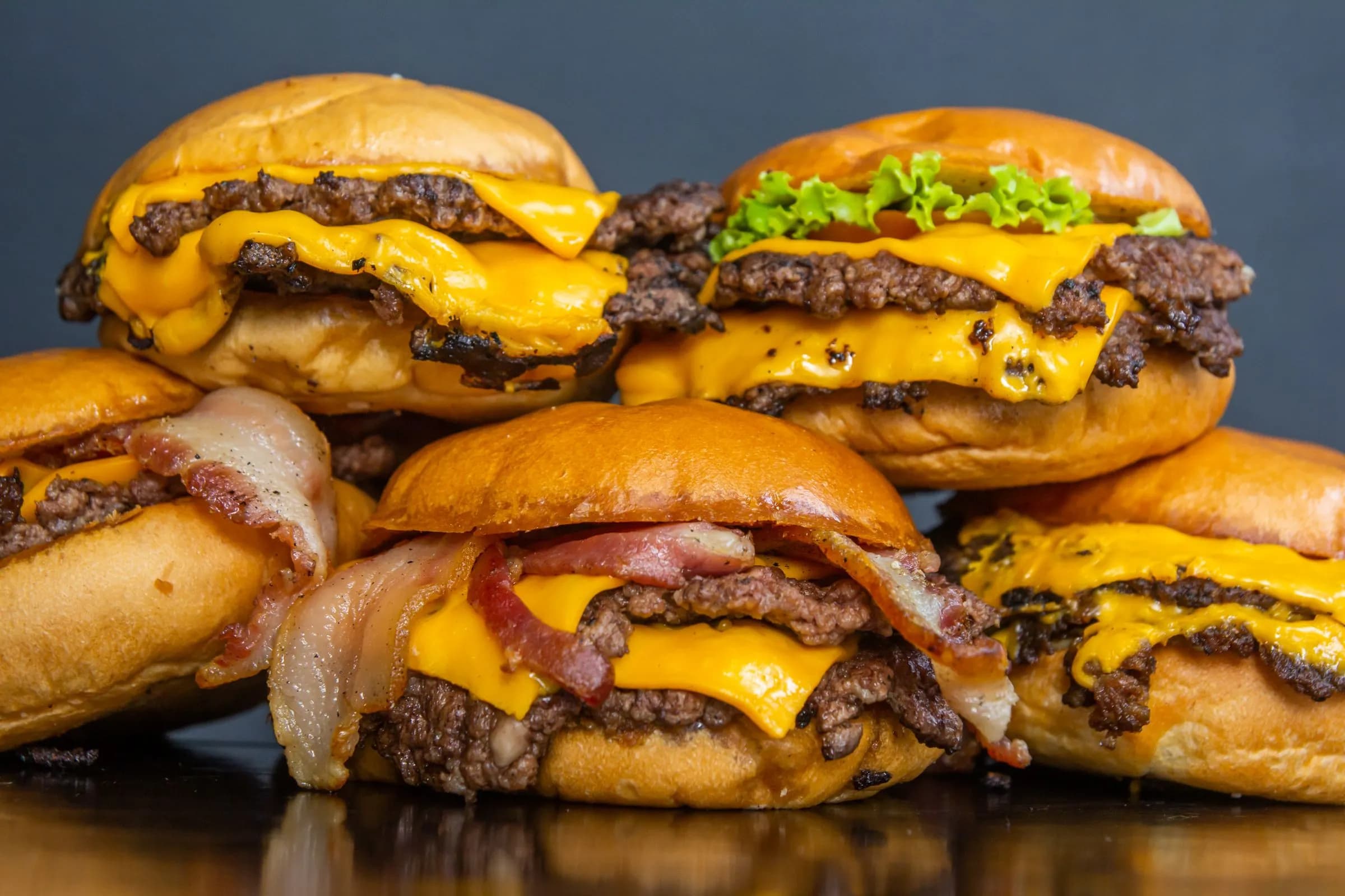 Stacked double cheeseburgers with melted cheese and crisp-edged patties